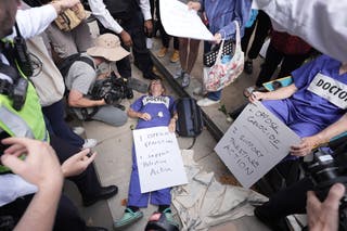 A demonstrator lies down amidst the protest in Westminster